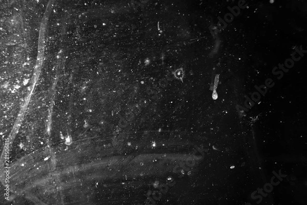 Fototapeta white dust and scratches on a black background. The texture of dirt on the glass.