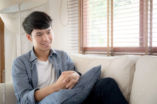 Fototapeta Portrait young handsome asian man napping relax with cozy on sofa at home, asia male resting and sleeping in weekend with tired and lazy on couch in vacation, lifestyle and wellbeing concept.