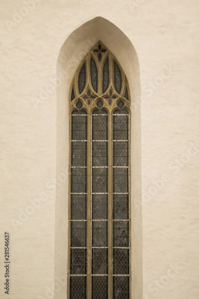 Fototapeta Unusual window on the facade of the old house