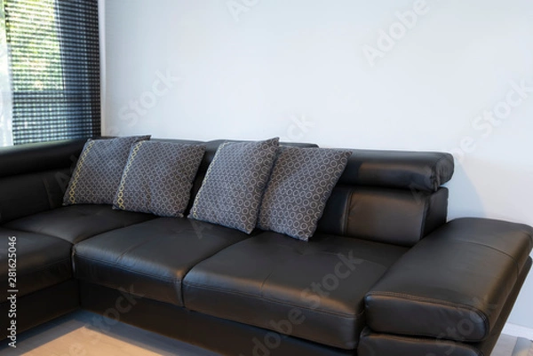 Obraz Modern interior of living room with comfortable black leather sofa