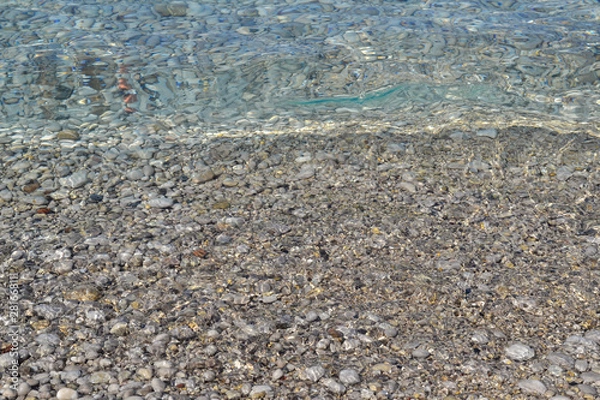 Fototapeta Abstract beach background texture with pebbles, sands and sea water in bodrum turkey