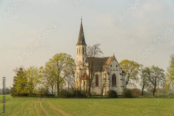 Fototapeta Neogothic Sidzina church in Lower Silesia standing alone amongst spring fields