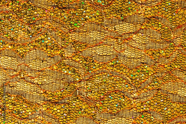 Fototapeta Abstract textured background of netting fabric with gold sequins