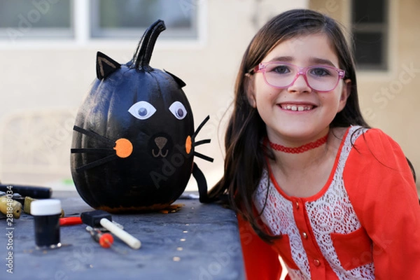 Obraz A family is decorating pumpkins during Halloween.
