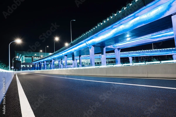 Obraz Empty road floor with city viaduct bridge of neon lights night