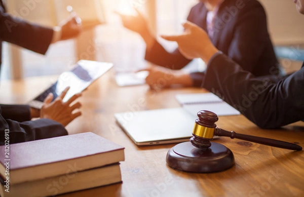 Fototapeta Group of business people and lawyers discussing contract papers ,Consultation between a male lawyer and businessman concept
