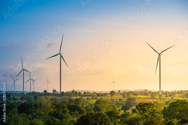Fototapeta Green energy concept, eco power. Wind turbine located along the hill with the wind blowing all the time. Can produce renewable energy as well. Considered a clean energy.
