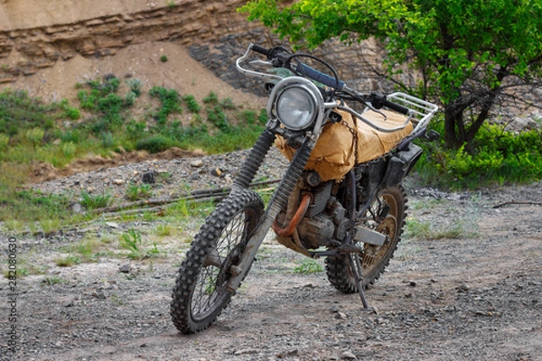 Fototapeta The steampunk motorcycle stands on the stony ground without rider