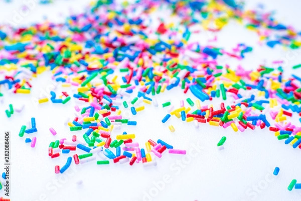 Fototapeta Colorful candy sprinkles close up for birthday cake on white background