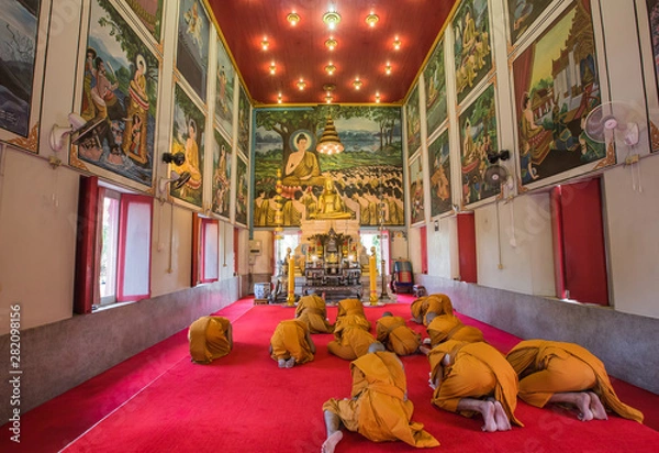 Obraz Monks pay respect to Buddha Statue in Wat Rat Bamrung (Wat Ngon Kai) - Samut Sakhon, Thailand
