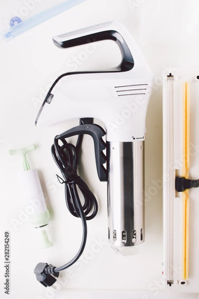 Obraz Sous vide stick or rooner close up, top view of a modern utensil for the sous vide cooking technique, ooner,  precision immersion circulator. Isolated on clean background. 