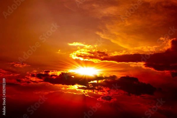 Fototapeta Beautiful red sunset above the clouds with rays of light