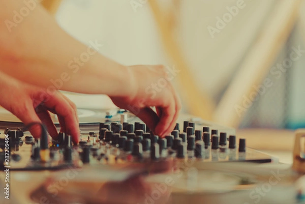 Obraz Summer music festival. Dj's sound equipment and people on blurred background.  Shallow depth of field