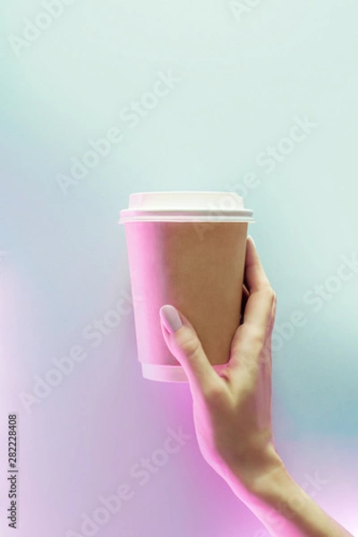 Obraz Cardboard cup of coffee to go on blue and pink neon background