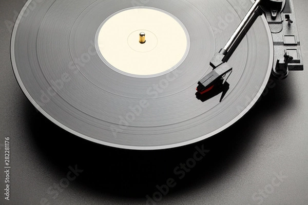 Fototapeta Black vinyl record player on black table background