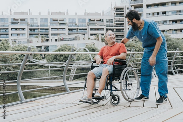 Obraz disabled man who goes in a wheelchair is transported by a doctor