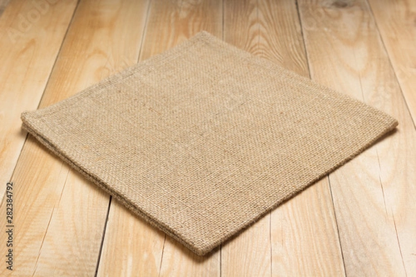 Fototapeta burlap hessian sacking cloth on wooden table