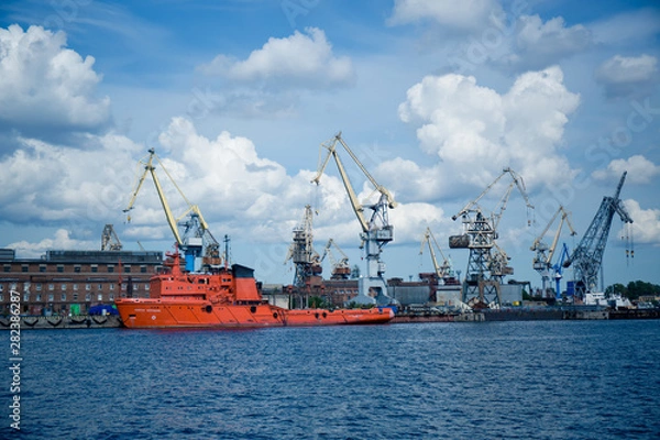 Fototapeta cargo cranes for unloading ships in the port