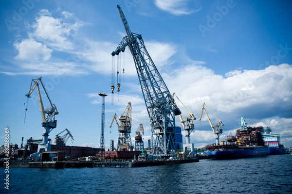 Fototapeta cargo cranes for unloading ships in the port
