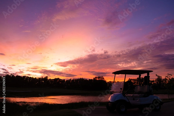 Fototapeta silhouette golf cart in golf course with colorful twilight sky soft cloud for background backdrop use