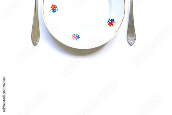 Obraz designer fragments of the served table for eating. Fork, spoon and plate - simple breakfast, lunch or dinner.