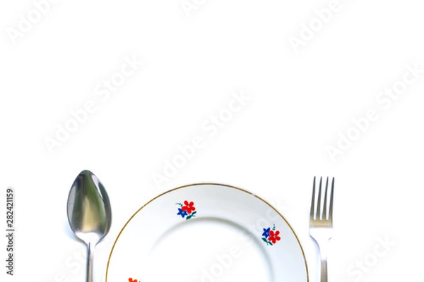 Obraz served table for meals. Fork, spoon and plate - simple breakfast, lunch or dinner.