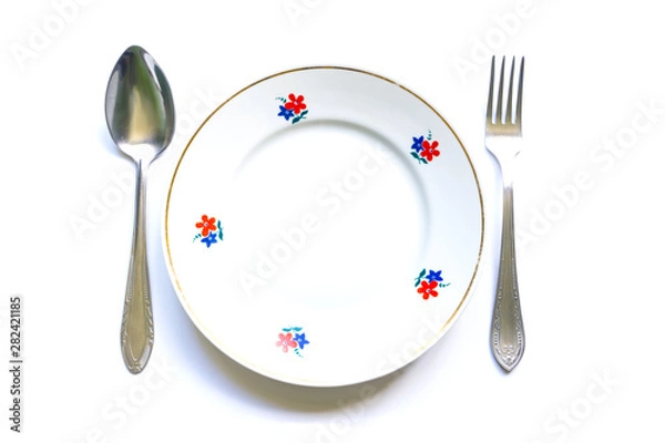 Obraz served table for meals. Fork, spoon and plate - simple breakfast, lunch or dinner.