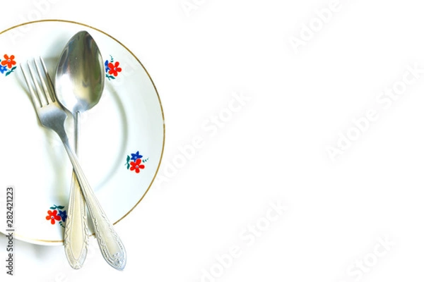 Obraz fork and spoon on an empty clean plate