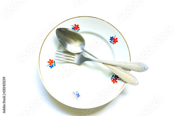Obraz fork and spoon on an empty clean plate