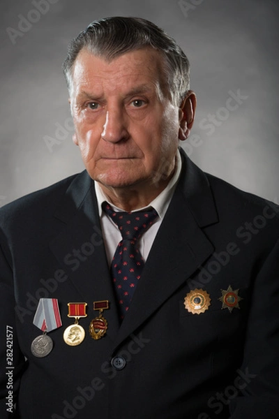 Obraz Portrait of an elderly gray haired man. On his chest medals of the Soviet period. A war veteran and hero of socialist labor. Studio photography.