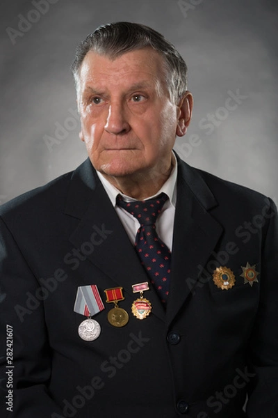 Obraz Portrait of an elderly gray haired man. On his chest medals of the Soviet period. A war veteran and hero of socialist labor. Studio photography.