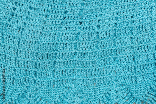 Fototapeta Knitted openwork pattern, turquoise color. Textured fabric. Handmade