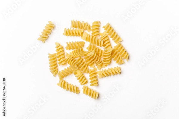 Obraz Various uncooked pasta on white background. Top view. Raw pasta with ingredients for cooking. Food concept
