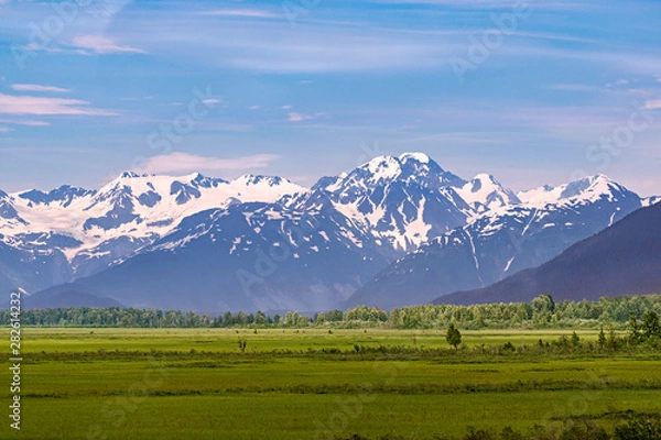 Fototapeta pastoral panorama of the chugach mountains and forest southeast of anchorage alaska with green meadows in the foreground