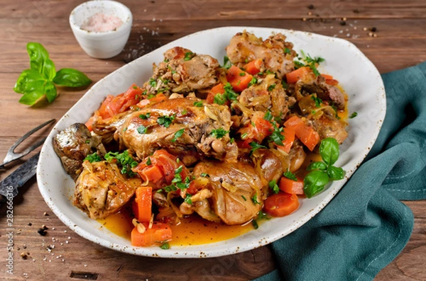 Fototapeta Roasted rabbit with vegetables and white wine sauce