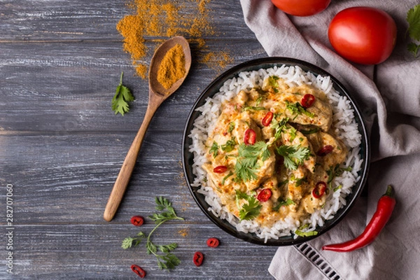 Fototapeta Top down view of a delicious chicken tikka masala with Indian spices and Basmati rice