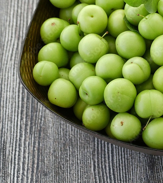 Fototapeta sour green plums, double bunch of plums