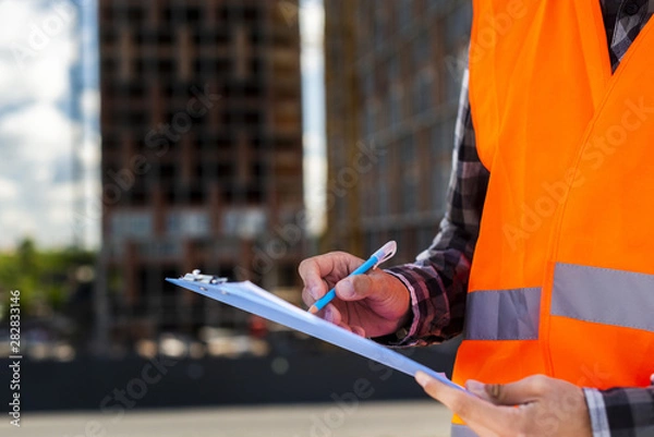 Fototapeta Close-up construction engineer writing