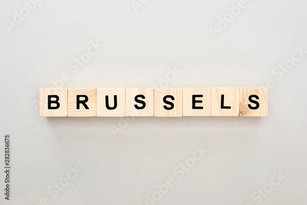 Fototapeta top view of wooden blocks with Brussels lettering on grey background