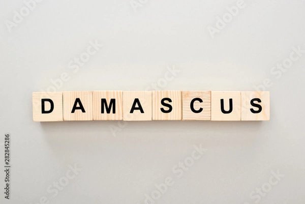 Fototapeta top view of wooden blocks with Damascus lettering on grey background