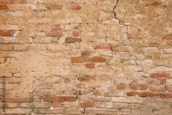 Fototapeta Old rough grunge concrete and brick wall, for usage as a background