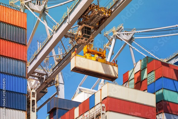 Obraz Close-up of how containers are being discharged from a large container ship by a crane in the port of Rotterdam, Europe