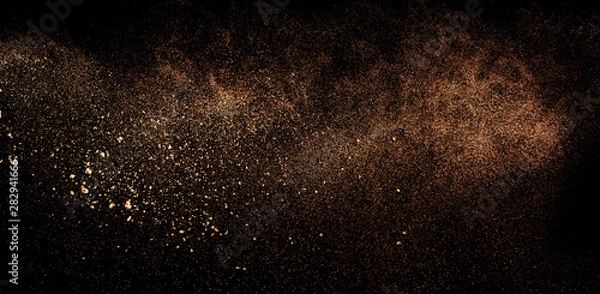 Fototapeta a shot from a firearm, an explosion of gunpowder on a black background, a bright flash with flying particles, abstract shape