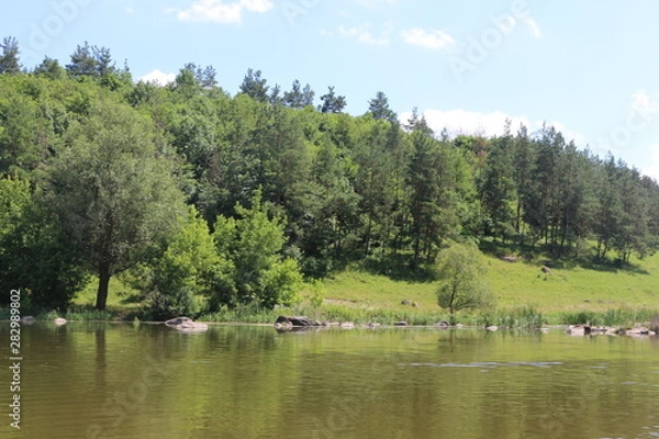 Fototapeta  The bank of the plain river invites tired travelers to relax