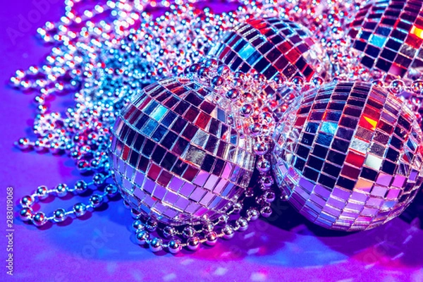 Fototapeta Shiny small disco balls sparkling in a beautiful purple light. Disco party concept