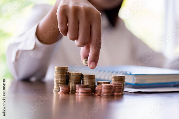 Fototapeta coins stacking, coins and money for finance and banking, saving money or interest increasing concept