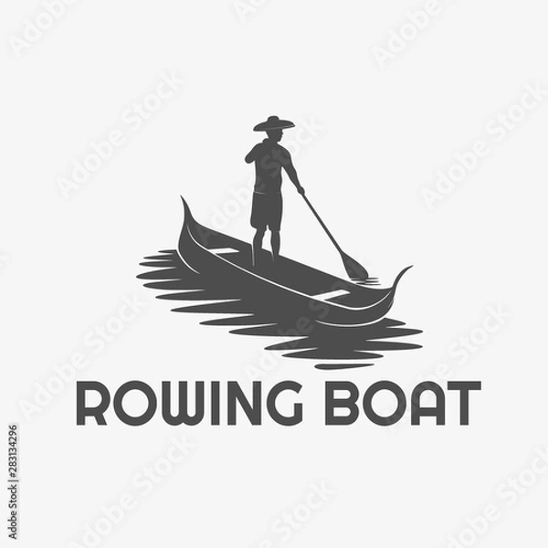Fototapeta silhouette of a man rowing a small boat