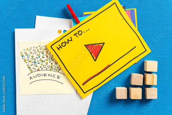 Fototapeta E-learning and how to video storytelling marketing concept made with a illustration on yellow paper and blue textured background.