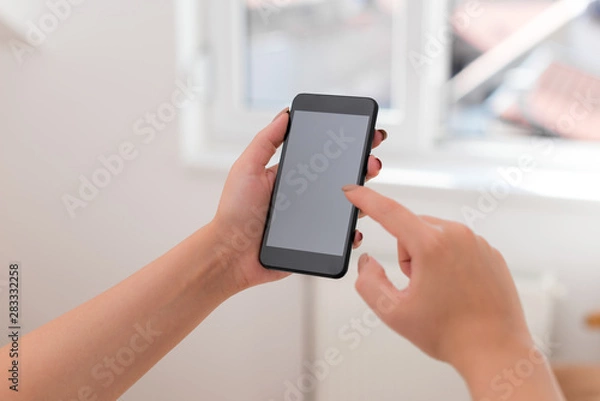 Fototapeta woman using smartphone office supplies technological devices inside home