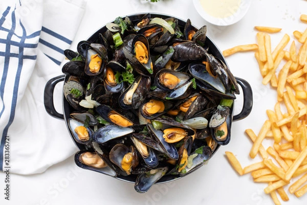 Fototapeta Belgian mussels with potato fries on white marble table flat lay view 